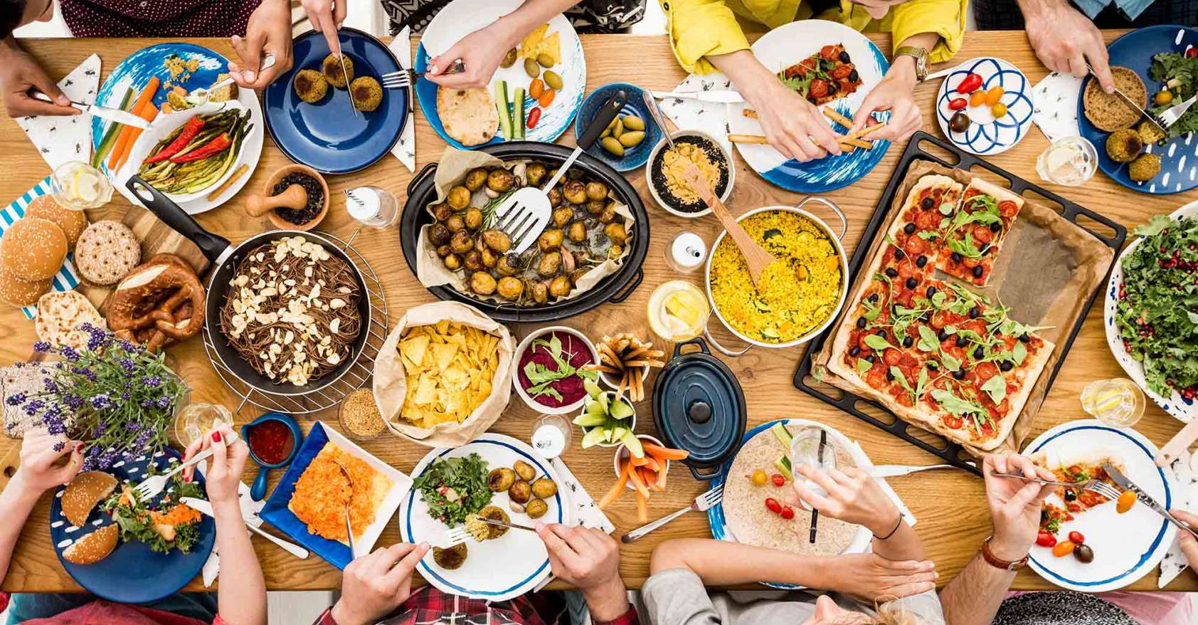 group of people at table eating vegetarian/vegan options