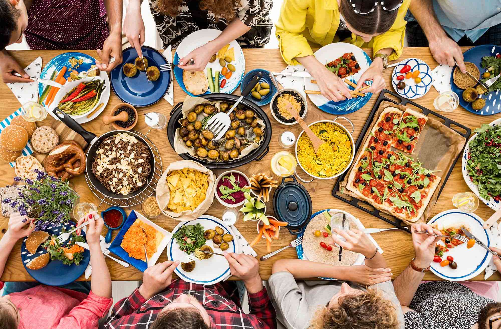 group of people at table eating vegetarian/vegan options