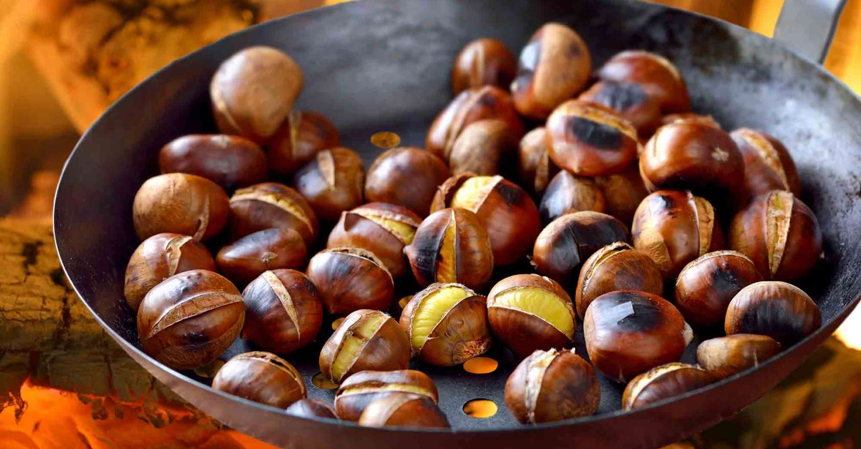 Chestnuts roasting in metal pan on an open fire nut allergy