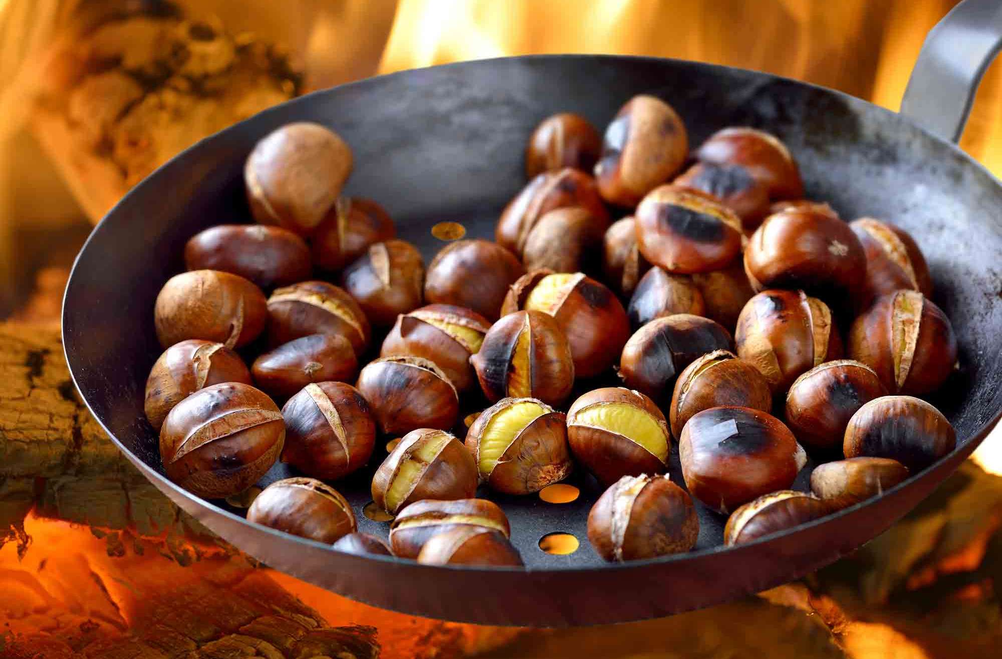 Chestnuts roasting in metal pan on an open fire nut allergy
