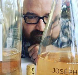 Man in glasses looking at beer carafes non-alcohol beverages