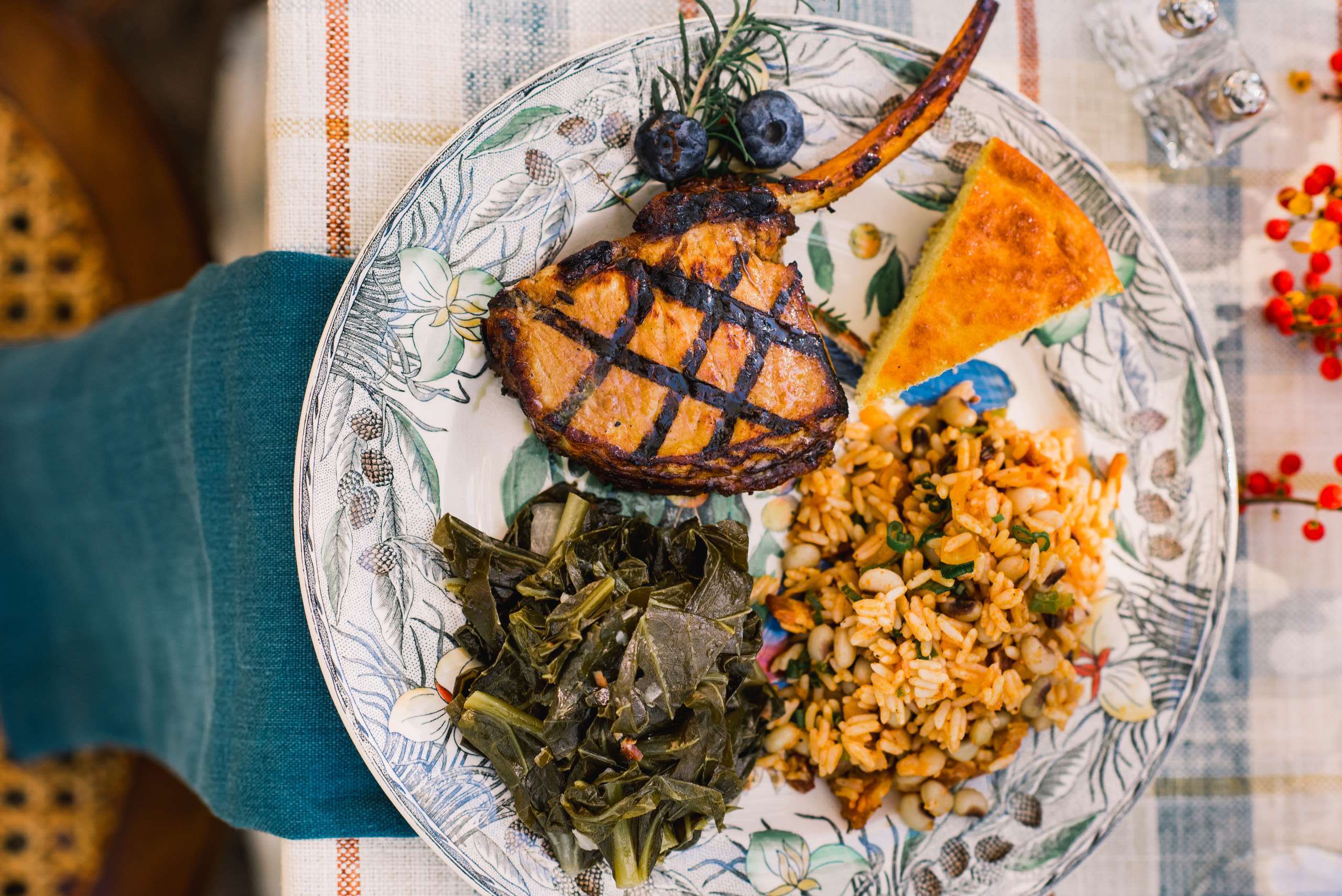 picture of beautiful Coastal Carolinas cuisine plated includes collards, golden rice, lamb shank and corn bread Salthouse Catering in Charleston, South Carolina