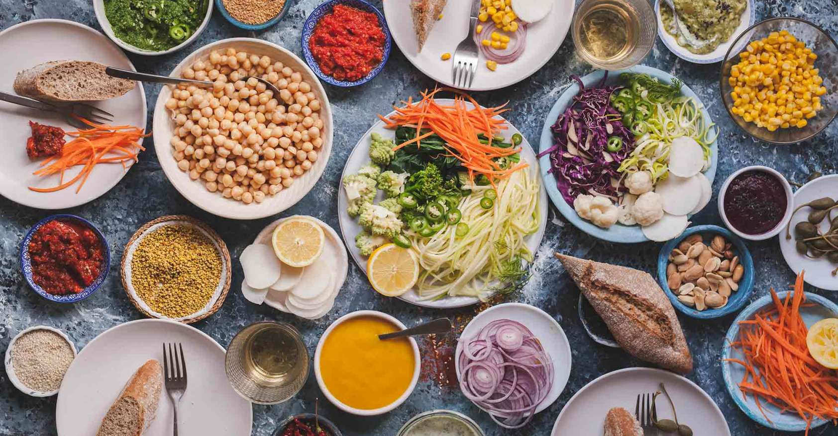whole foods plant-based Vegan veggies meals on dining table shot from above