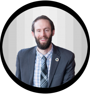 Smiling Man in a suit and tie he promotes creating earth-friendly Eating Experiences