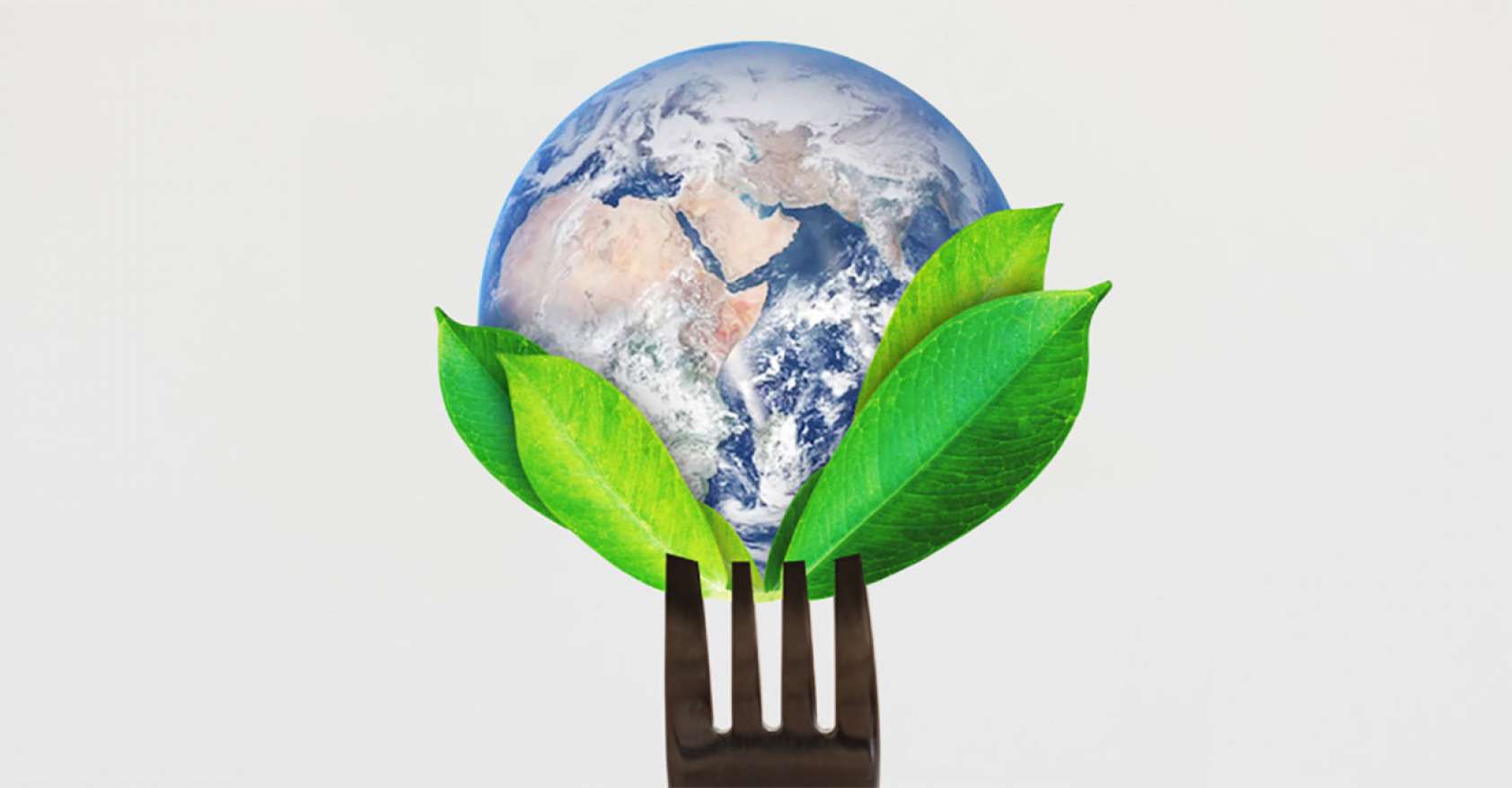 Globe on the tines of a fork with some green leaves Earth Day 2021