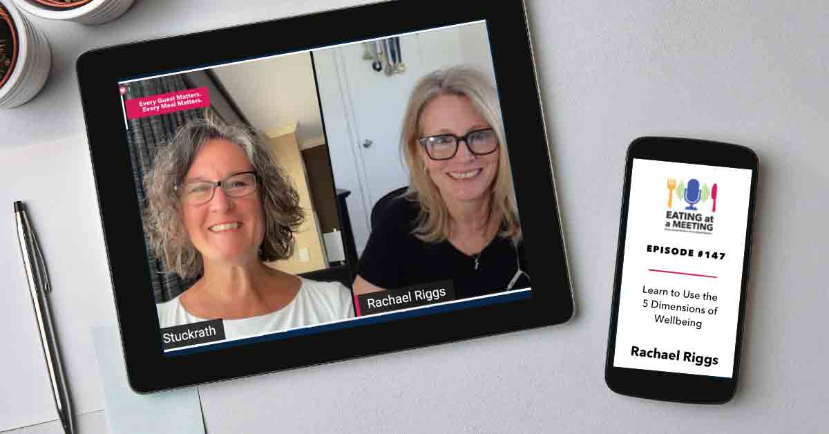 An iPad and iPhone on a table. On the iPad is a picture of two women who are on video screen. On the iphone is the Eating at a Meeting podcast logo with Episode #147 Learning to Use the 5 Dimensions of Wellbeing with Rachel Riggs