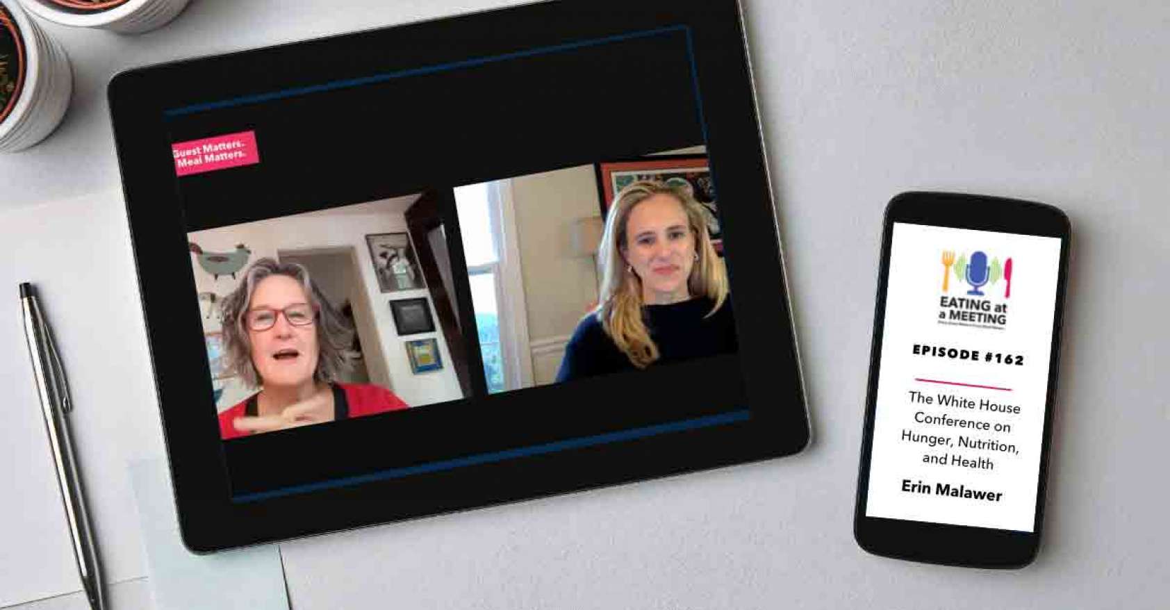 An iPad and iPhone on a table. On the iPad is a picture of two men who are on video screen. On the iPhone is the Eating at a Meeting podcast logo with Episode #163 The White House Conference on Hunger, Nutrition, and Health with Erin Malawer of Allergy Strong