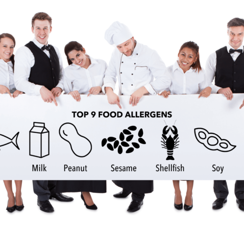 Group of catering staff holding a banner with the Top 9 Food Allergens icons across it.